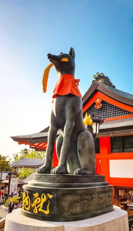 KYOTO, JAPAN %u2013 APRIL 18, 2019: Fox statue holding a rice plant in the mouth at the main gate of Fushimi Inari Taisha Shrine, kyoto Japan.のeditorial素材