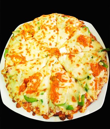 Fresh homemade cheese pizza with fresh vegetables on top served on white plate.の写真素材