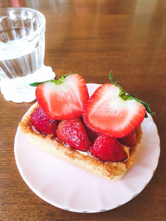 Strawberry Tart on a white plate,  sweet  dessert in afternoon coffee or teaの写真素材