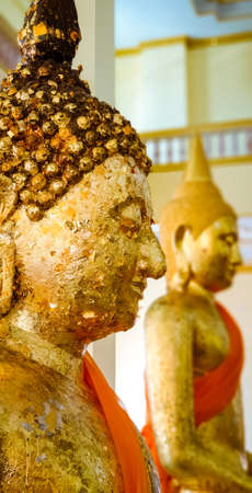 Close up Golden Buddha face statue in the templeの写真素材