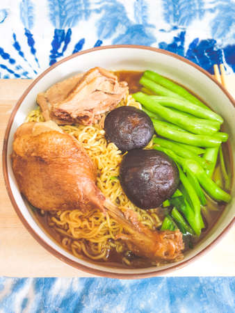 Ramen asian noodle with steamed duck, green vegetables and mushrooms on a bowlの写真素材