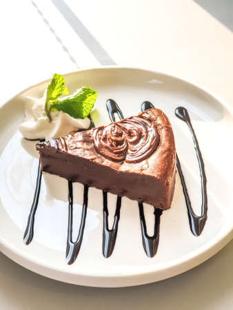 Chocolate cake served with cream on a plate, Afternoon tea.の写真素材