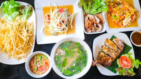 Thai traditional food set, Somtum, Spicy soup, grilled pork, grilled chicken and spicy dip.の写真素材
