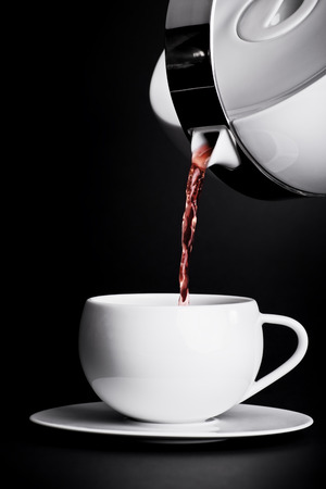 Pouring tea on black backgroundの写真素材