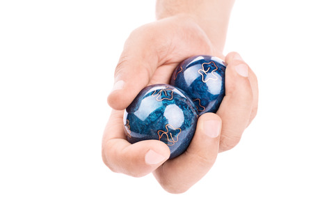 Close-up shot of a male hand holding Baoding balls isolated on white backgroundの写真素材