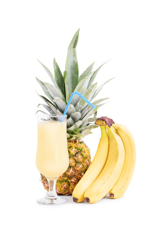 Bananas, pineapple and a glass of juiceの写真素材
