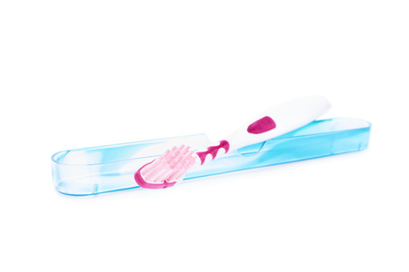 Toothbrush with a protective cover isolated on white backgroundの写真素材