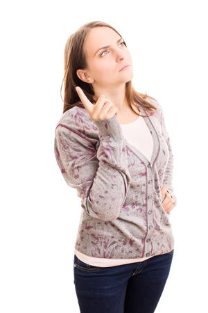 Young girl holding her point finger up thinking about something isolated on white backgroundの写真素材