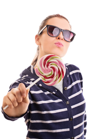 My sweet, sweet lollipop. Young girl wearing sunglasses isolated on white backgroundの写真素材