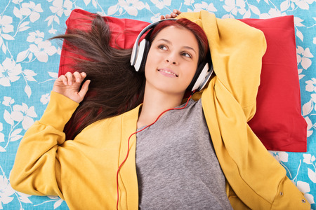 My dream song. Young girl in her bed listening music