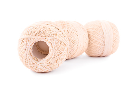 Aligned spools of knitting threads isolated on white background