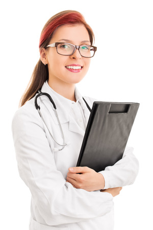 Portrait of a young doctor holding a notepad isolated on white backgroundの写真素材