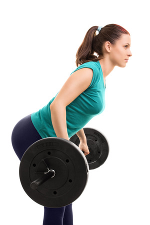 Lift! Young girl athlete lifting weights, isolated on white background.の写真素材