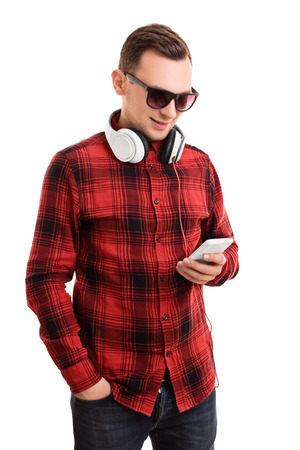 A portrait of a casually dressed student texting, isolated on white background.の写真素材