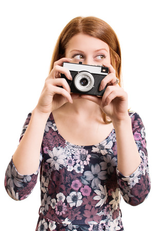 A portrait of a beautiful young girl holding a vintage camera, isolated on white background.の写真素材