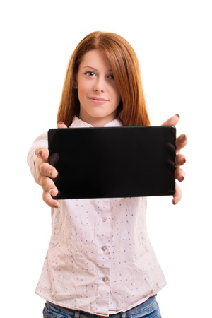 A portrait of a beautiful smiling girl, holding a tablet, isolated on white background.の写真素材