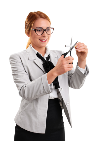 Young modern business woman cutting a cigarette with scissors, isolated on a white background.の写真素材