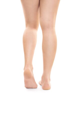 Back shot of smooth beautiful female legs, isolated on white background. Successful hair removal procedure.の写真素材