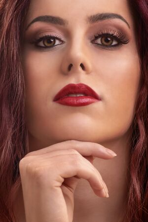 Close up portrait of a beautiful female model with make up, red lipstick and clean skin.の写真素材