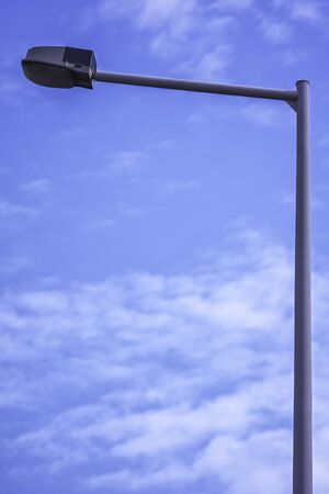 Close up shot of a single street light with a clear blue sky in the background.の写真素材
