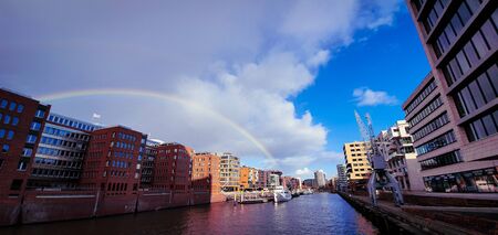 Beautiful rainbow over Hamburg canal. Beautiful wide angle view from the Kaiserkai bridge on the...