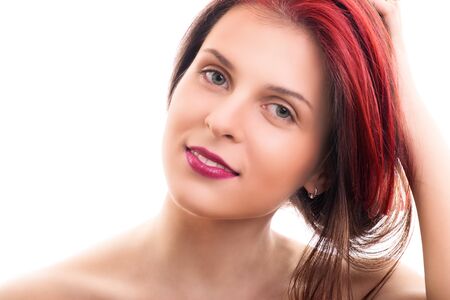 Sensual portrait of a beautiful young woman with soft clean make up, holding her hair, isolated on white background. Fashion and beauty concept.の写真素材