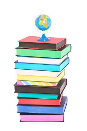 A globe on top of stack of colorful books with different sprayed edges, isolated on white background. Education and travel concept.の写真素材