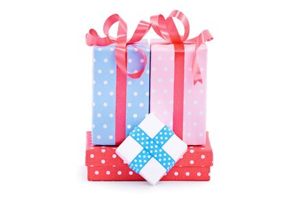 Pile of gifts, wrapped in cute wrapping paper and ribbons, isolated on white background. Christmas, New Year, anniversary, birthday, Valentineâs Day concept.の写真素材