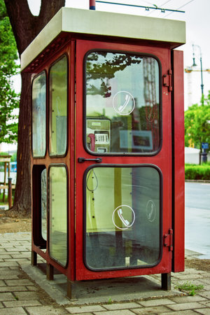 Old telephone booth in Budapest, Hungary. An old public phone in Budapest. Types of communication of the past.の写真素材