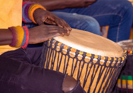 Close up of an African djembe drummer. Drummer playing African percussion music. Ethnic percussion...