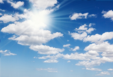 Sun in blue sky with cloudsの写真素材