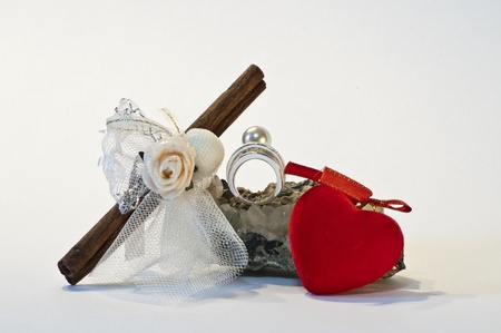 A decoration fot wedding composed by a ring, a testimony and a little heartの写真素材