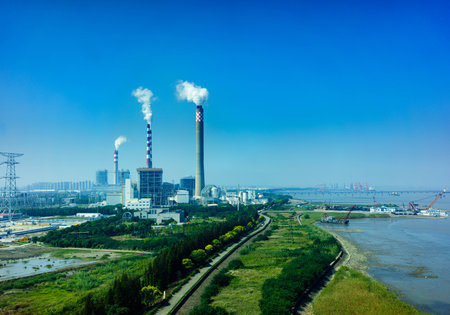 Smoking smokestack of chemical plant with blue skyの写真素材