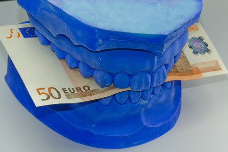 total prosthesis in blue with banknotesの写真素材