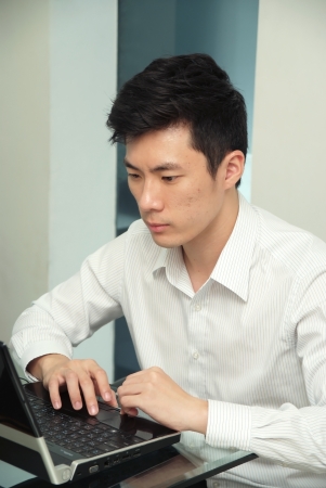 The young chinese businessman concentrate this jobの写真素材