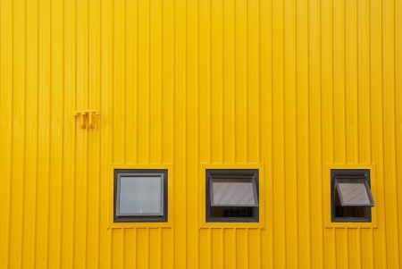 Three windows  on yellow wall