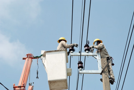 Electricians maintenance the wiring on the car liftsの写真素材