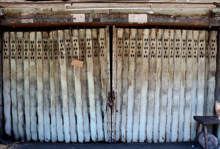 The old rolling steel door front the deserted houseの写真素材