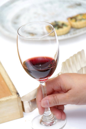 A glasses of red wine and snack on the meeting tableの写真素材