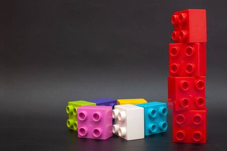 Colorful Lego cubes on a black background. Copy space, learning gamesのeditorial素材
