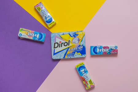 Russia, Ulyanovsk, 27 April 2020. Assortment of gums of different brands on a colored backgroundのeditorial素材