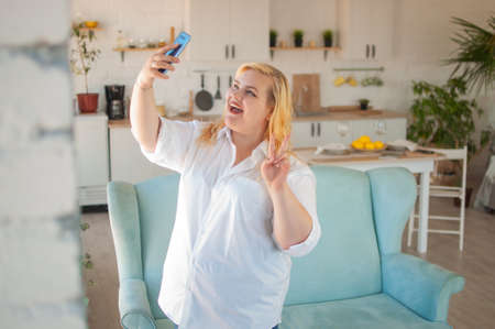 Hilarious overweight woman shoots herself on social media videoの写真素材
