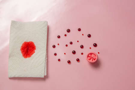 Metaphor of the anus on a pink background. Rectal bleeding, hemorrhoids.の写真素材