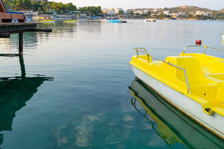 Yellow pedal boat on the blue seaの写真素材
