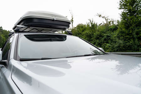 Silver colored car with roof box during a trip on vacationの写真素材