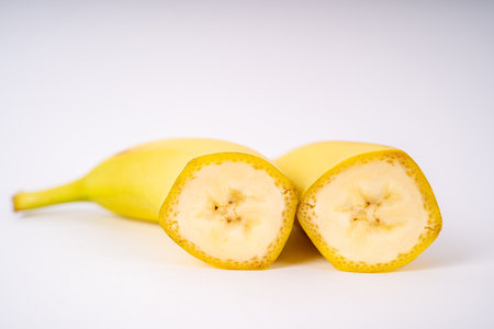 Two banana halves with white backgroundの写真素材