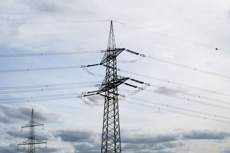 Electric pole on a cold afternoon with a cloudy sky in the backgroundの写真素材