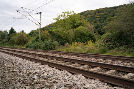 Two railway tracks in a rural environment with a cloudy skyの写真素材