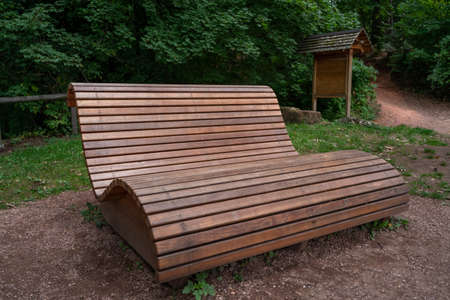 Wooden curved relaxing bench in the parkの写真素材