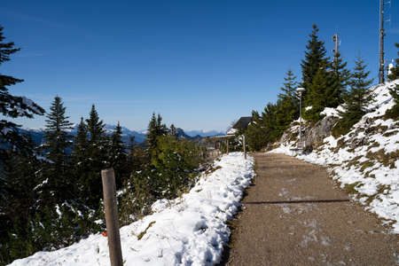 Walkway in the mountains with snow on the sides on a sunny day in winterの写真素材